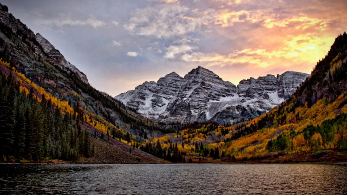 body of water across the mountain during sunset